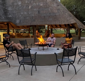 Guests relaxing around a fire pit